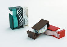 shows mt tape cutter usage with rolls of tape